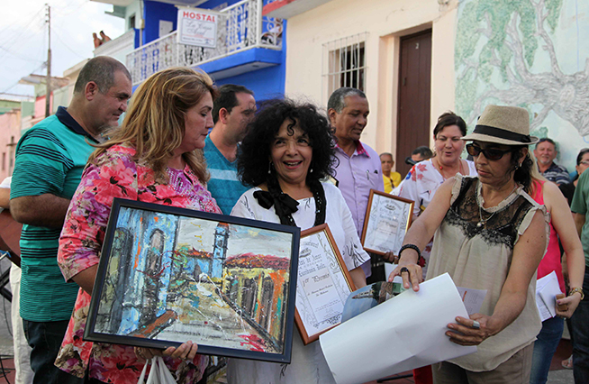 Ileana Mulet (C), distinguida artista de la plástica, recibe el Primer Premio en la XIX Edición del Concurso Internacional Cartas de Amor, auspiciado por la Escribanía Dollz, como una de las actividades colaterales más distinguidas de la presente edición de la Feria Internacional del Libro, en Sancti Spíritus, Cuba, el 30 de marzo de 2019. Ileana Mulet (C), distinguida artista de la plástica, recibe el Primer Premio en la XIX Edición del Concurso Internacional Cartas de Amor, auspiciado por la Escribanía Dollz, como una de las actividades colaterales más distinguidas de la presente edición de la Feria Internacional del Libro, en Sancti Spíritus, Cuba, el 30 de marzo de 2019.